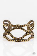 Load image into Gallery viewer, Speaks Volumes - Brass Item #P9ED-BRXX-033XX Encrusted in glittery aurum rhinestones, dotted brass bars wind across the wrist, coalescing into an edgy cuff.